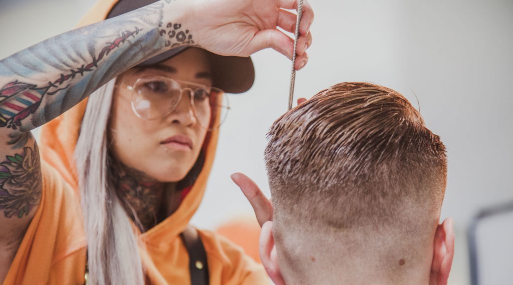 Pivot Point stylist completing a men's hair design