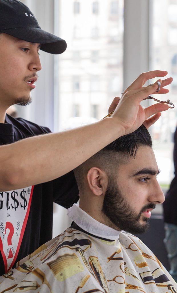Pivot Point barber cuts a client's hair