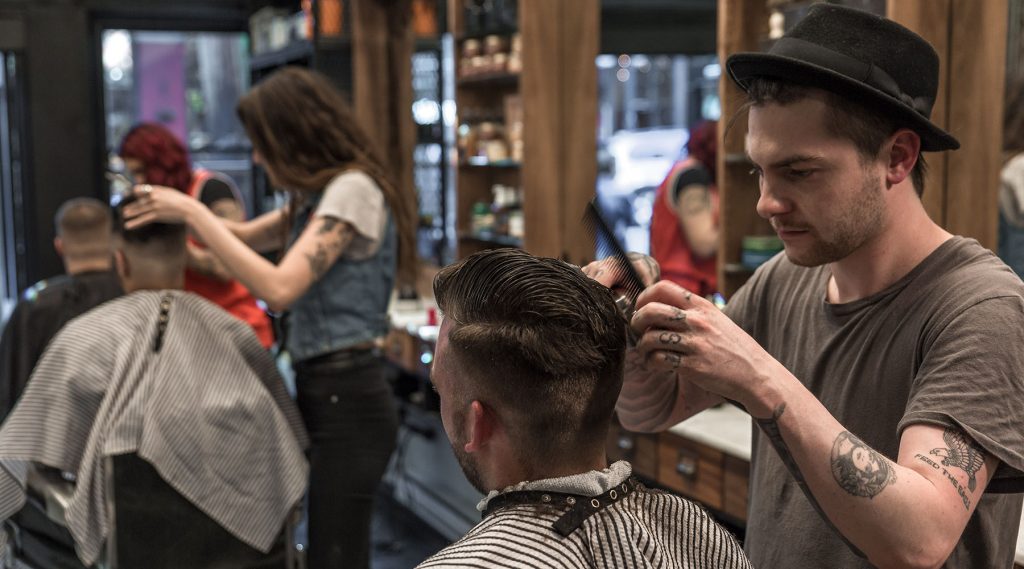 Pivot Point barber cuts a client's hair