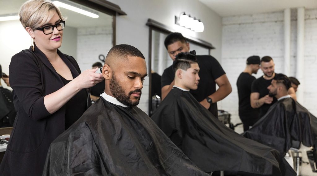Pivot Point stylist completing a men's hair design