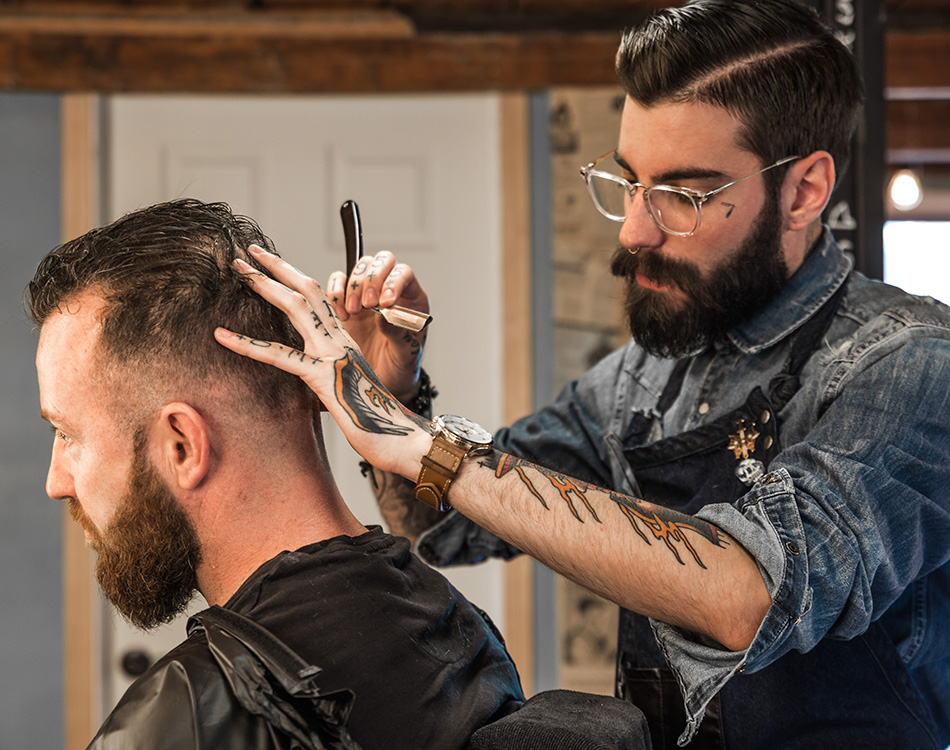 Pivot Point barber using straight razor on client