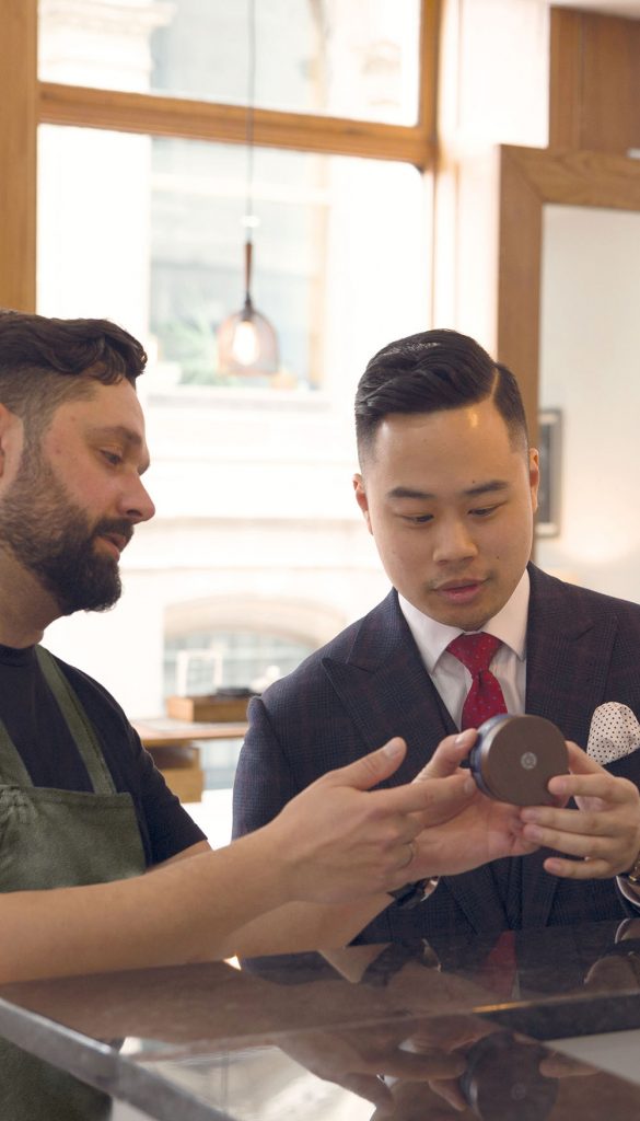 Barber showing client product in a modern store