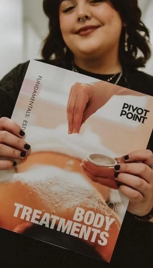 Pivot Point Esthetics Student Holding Book